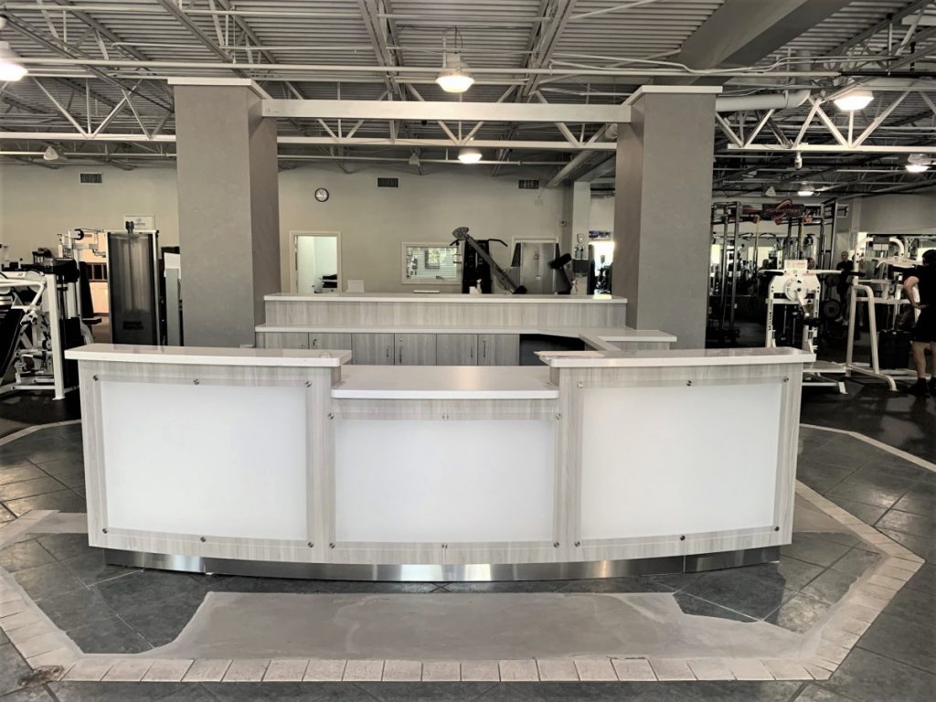 IMG 2934 During Summer of 2020 we worked with the owners of Jupiter Fit, in Jupiter, FL to design and build their fitness center custom cabinets.  This project involved a custom reception/front desk with built in retail display, a fuel & gear retail area, training station POD, and member lockers with interior brand graphics and signage.